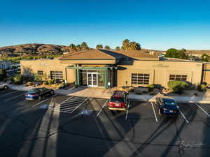 View of building exterior with uncovered parking and a mountain view