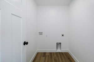 Washroom with hookup for an electric dryer, dark wood finished floors, and hookup for a washing machine