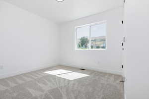 Empty room with carpet and baseboards