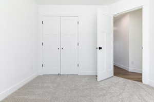 Unfurnished bedroom featuring carpet floors and a closet