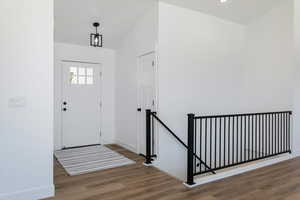 Foyer entrance featuring wood finished floors and baseboards