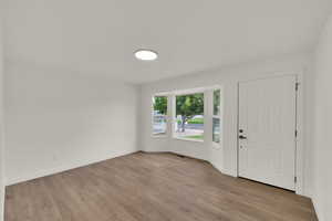 Entrance foyer with light wood-type flooring and baseboards