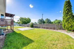 Fenced backyard with a patio area