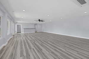 Unfurnished living room featuring recessed lighting, light wood-style floors, and a ceiling fan