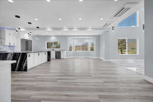 Unfurnished living room featuring plenty of natural light, recessed lighting, and light wood-type flooring