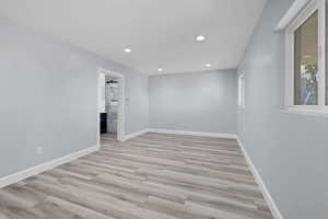 Empty room featuring recessed lighting and light wood-style floors