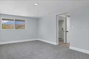 Unfurnished room featuring light colored carpet and recessed lighting