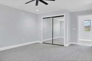Unfurnished bedroom featuring light carpet, a closet, recessed lighting, and a ceiling fan