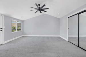 Unfurnished living room with light colored carpet, a ceiling fan, vaulted ceiling, and recessed lighting