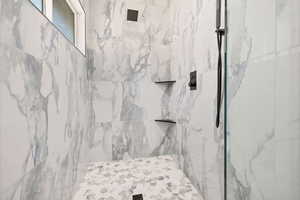 Bathroom with a marble finish shower