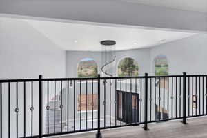 Corridor featuring wood finished floors and recessed lighting