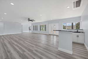 Unfurnished living room with recessed lighting, light wood-style flooring, and ceiling fan