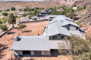 Aerial view of property and surrounding area featuring a mountain backdrop