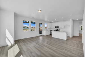 Unfurnished living room with light wood-type flooring and recessed lighting