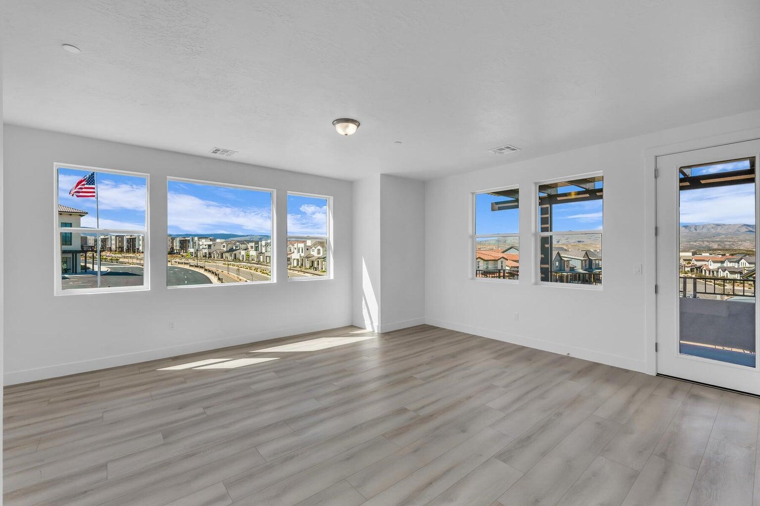 Unfurnished room featuring wood finished floors and a textured ceiling