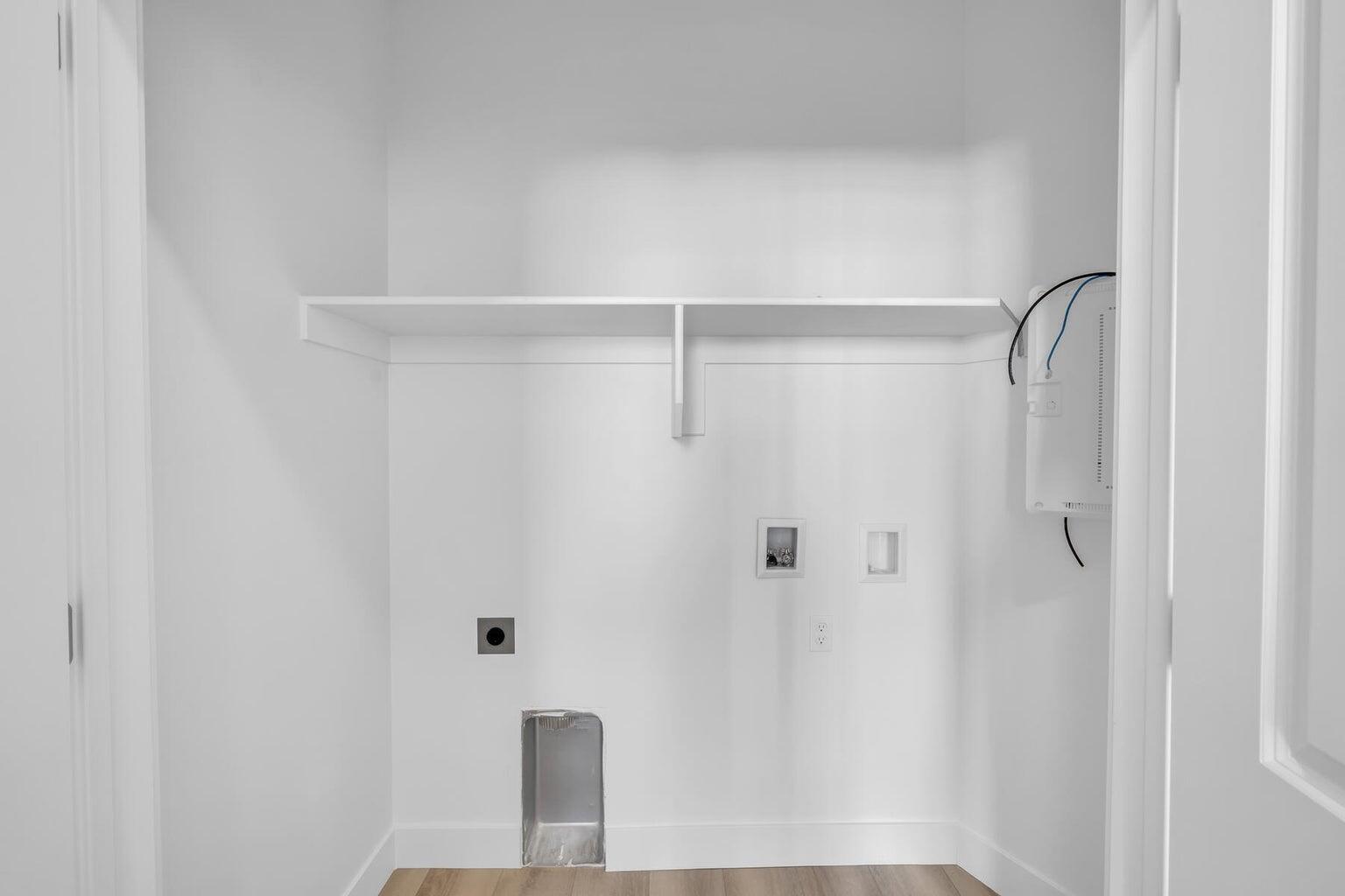 Laundry room featuring washer hookup, hookup for an electric dryer, and wood finished floors