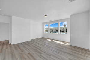Spare room with wood finished floors and baseboards