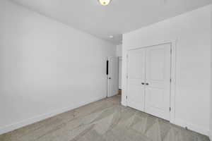 Unfurnished bedroom with carpet and a closet