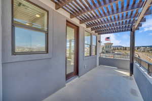 Balcony with a pergola and a sunroom