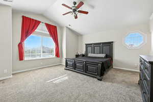 Bedroom with carpet floors, vaulted ceiling, and a ceiling fan