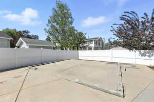 Fenced backyard with a patio area