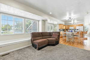 Living room with light colored carpet and a textured ceiling