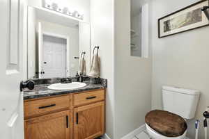 Half bathroom with vanity and tile patterned floors