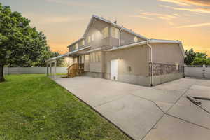 Rear view of property featuring stucco siding, a patio, and concrete driveway