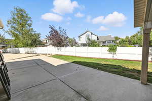 Fenced backyard with a patio area