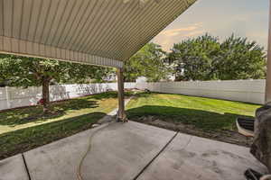 Fenced backyard featuring a patio area