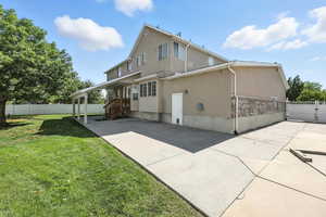 Rear view of property featuring stucco siding and a patio area