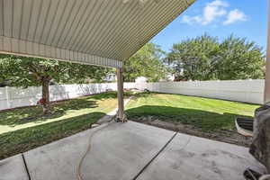 Fenced backyard with a patio