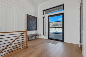 Foyer featuring wood finished floors and baseboards