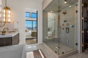 Full bathroom with ensuite bath, vanity, and a stall shower