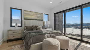 Bedroom featuring light wood-style flooring, access to outside, a mountain view, and recessed lighting