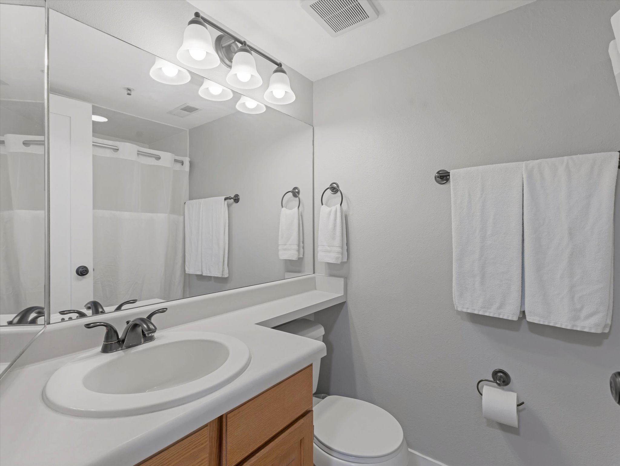 Bathroom featuring vanity and a shower with shower curtain