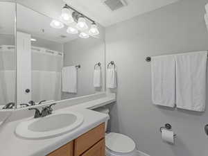 Bathroom featuring vanity and a shower with shower curtain