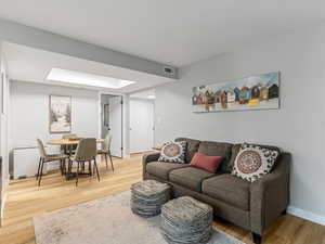 Living room featuring light wood-style floors and baseboards