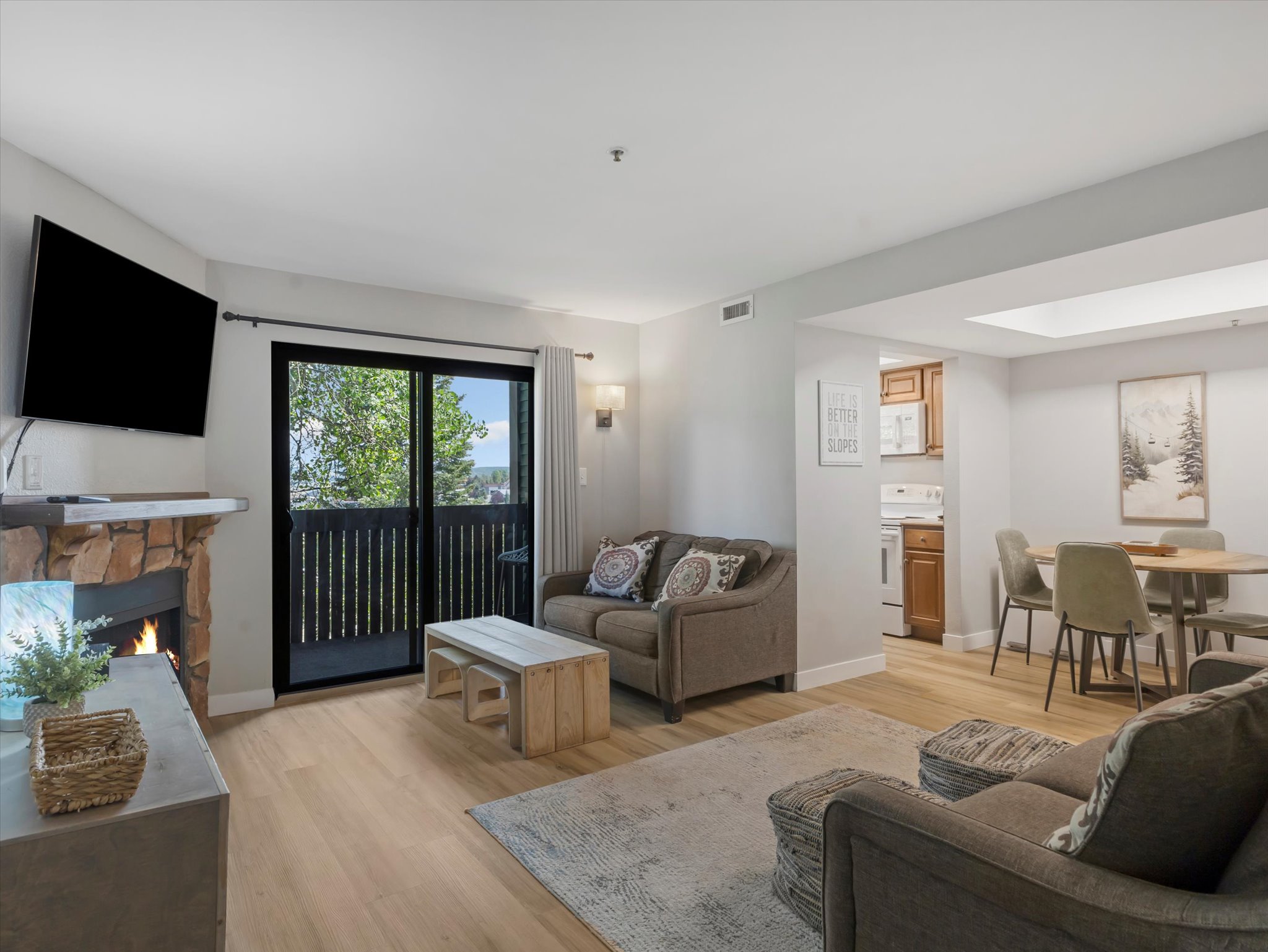 Living room with light wood-style floors and a fireplace