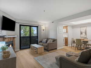 Living room with light wood-style floors and a fireplace