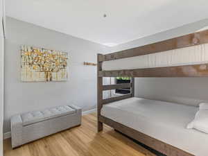 Bedroom with wood finished floors and baseboards