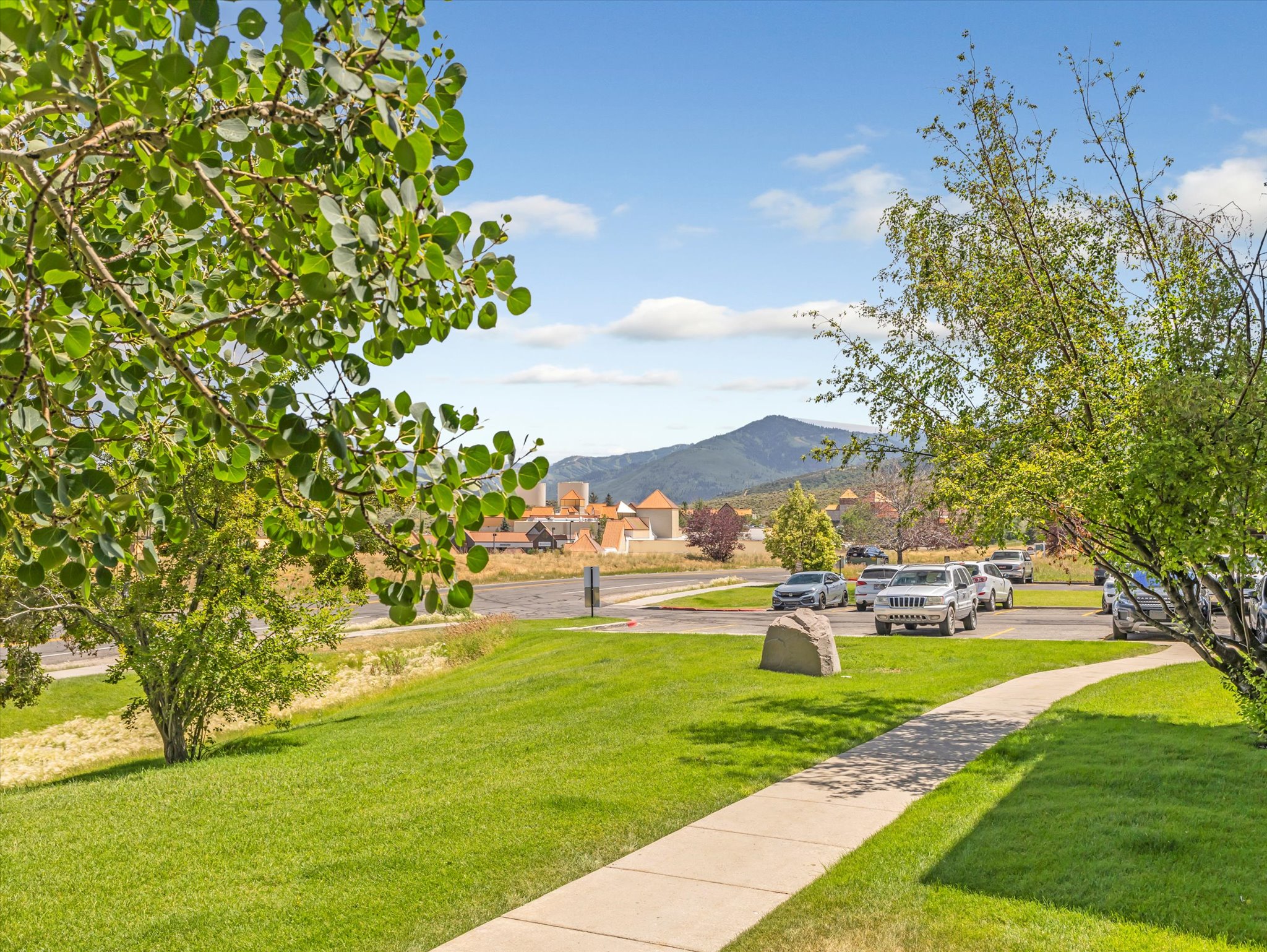 View of grassy yard with a mountain view