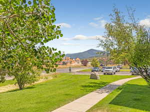 View of grassy yard with a mountain view