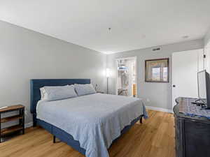 Bedroom featuring light wood finished floors and baseboards