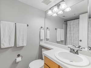 Full bath with vanity and curtained shower