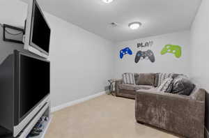 Carpeted living room featuring baseboards