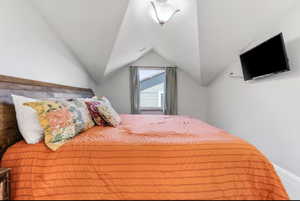 Bedroom with vaulted ceiling
