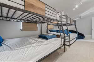 Bedroom featuring carpet floors and baseboards
