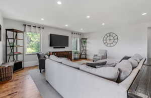 Living room with hardwood / wood-style flooring and recessed lighting