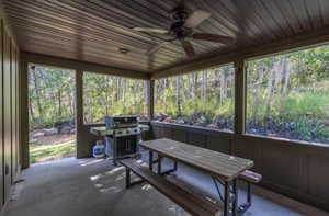 Sunroom featuring a ceiling fan